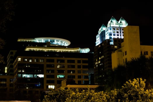 Low angle view of buildings lit up at night, Orlando, Florida, USA