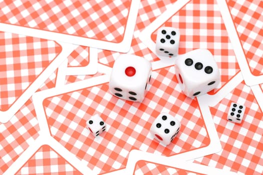Dice on playing cards background. Game concept