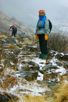Portrait of a female hiker standing on a mountain, Machhapuchhare, Annapurna Range, Himalayas, Nepal