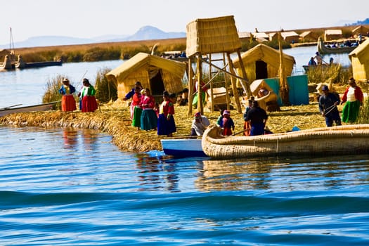 Group of people at a lakeside, Lake Titicaca, Uros Floating Islands, Puno, Peru