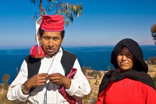 Portrait of a newlywed young couple standing, Taquile Island, Lake Titicaca, Puno, Peru