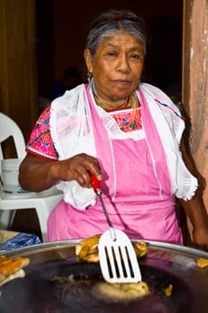 Portrait of a senior woman cooking, Cuetzalan, Puebla State, Mexico