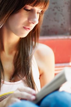 Close_up of a young woman reading a book