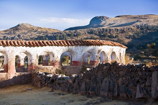 Stone wall in front of a building, Chicuito, Puno, Peru