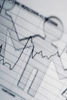Close_up of the outline of paper chain dolls on an ECG report