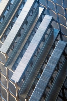 Close_up of staples on a metal grille