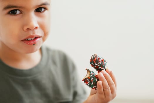 Portrait of a boy eating candy