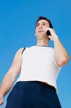 Low angle view of a mid adult man talking on a mobile phone