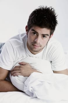 Close_up of a young man lying on the bed
