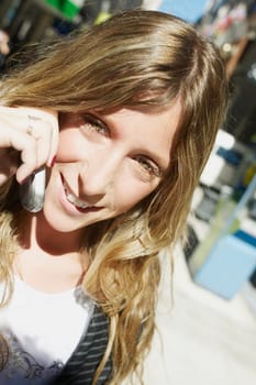 Close_up of a young woman talking on a mobile phone and smiling