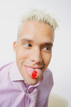 Close_up of a young man sticking his tongue out