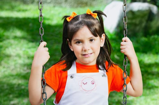 Portrait of a girl on a chain swing ride