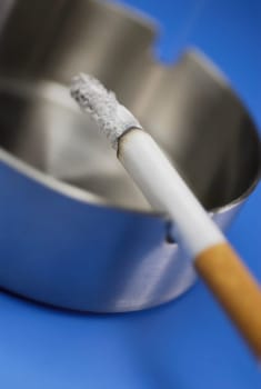 Close_up of a cigarette in an ashtray