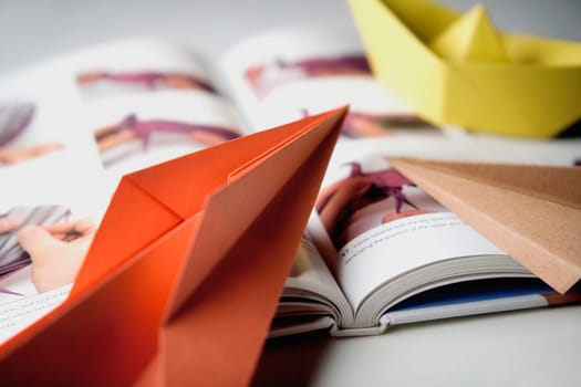 Close_up of a book with paper boats
