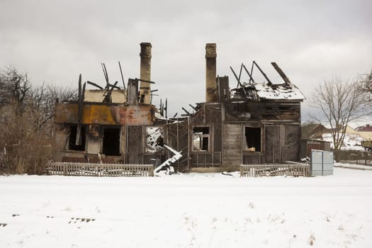Burnt wooden house. House after the fire. House destroyed in a gas explosion .