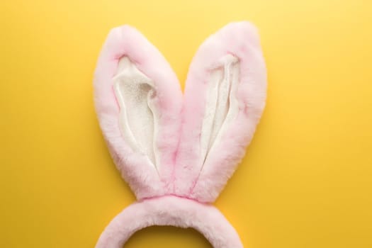 Pink Easter bunny ears on the yellow background. High quality photo