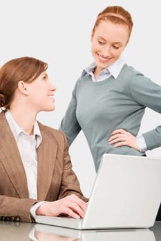 Two businesswomen smiling at each other