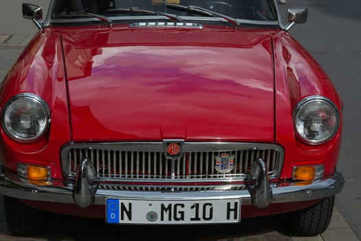 HEILIGENHAUS, NRW, GERMANY - SEPTEMBER 10, 2017:..Oldtimer Morris Garages Model MGB front view in  red color, parked in Heiligenhaus, Deutschland.