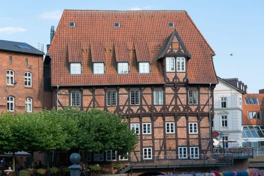 LÜNEBURG, NIEDERSACHSEN, GERMANY - JULI 27, 2018:..Half-timbered red brick houses near the river on the old harbor Lueneburg, Germany