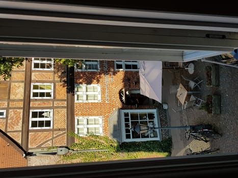 LÜNEBURG, NIEDERSACHSEN, GERMANY - JULI 27, 2018:..View from a hotel window onto a small market square and a coffee roasting plant in Lüneburg.