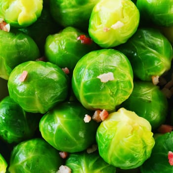Background texture of fresh steamed, boiled or microwaved brussels sprouts with savory seasoning, square format