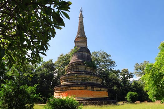 Ancient half overgrown Pagoda at underground temple Wat UMong Chiangmai, Thailand.