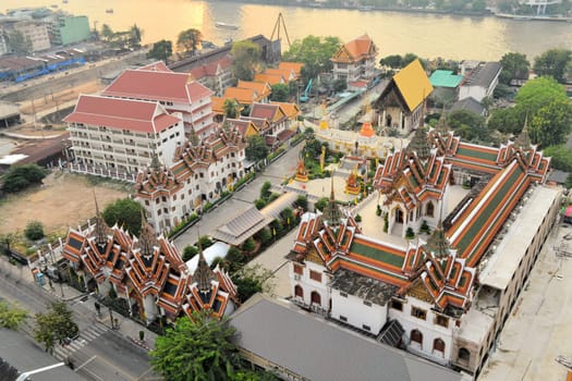 Aerial view of Wat Suthiwararam Buddhist temple from abandoned skyscraper Sathorn Unique, Bangkok, Thailand