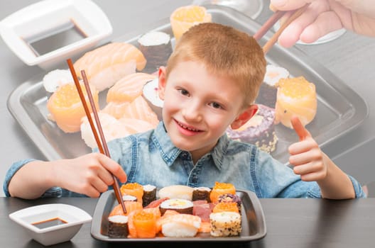an happy young boy ready for eating sushi