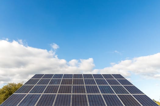photovoltaic solar power panel on sky background, alternative electricity source, concept of sustainable resources, green energy concept