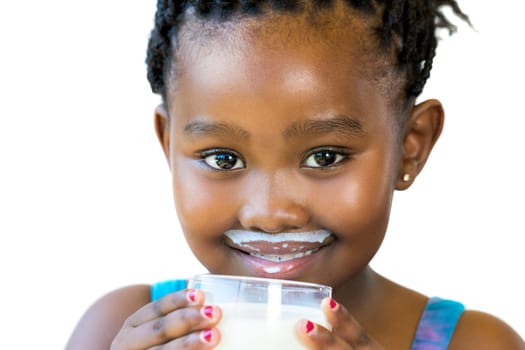 Close up face shot of sweet african girl with milk mustache.Girl holding glass of milk isolated on white background.