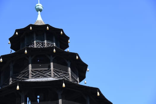 The top of the Chinese Tower in Munich in the English Garden. It was built between 1789 and 1790. Kochelball folk dance sight beer garden landmark pagoda beer bench concert Schwabing architectural style China tower city tour Bavaria Europe