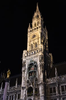 The town hall tower of the neo-Gothic New Town Hall in the Bavarian capital Munich with the famous Schäfflertanz and Glockenspiel at Marienplatz.