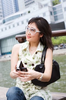 Close-up of a young woman holding a video camera