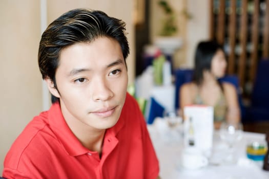 Close-up of a young man in a restaurant