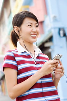 Close-up of a young woman listening to an MP3 player