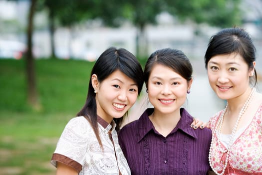 Close-up of three young women smiling