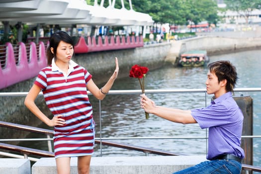 Side profile of a young man proposing a young woman