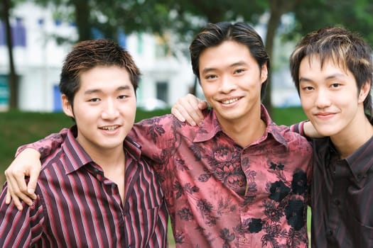 Portrait of three young men smiling
