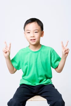 Portrait of a boy making a peace sign