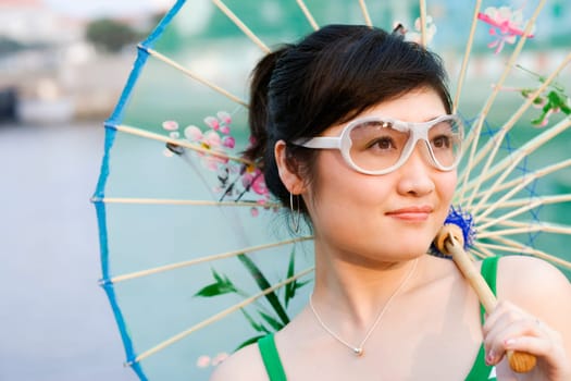 Close-up of a young woman holding a parasol
