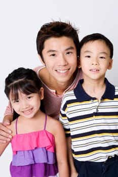 Portrait of a mid adult man smiling with his son and daughter
