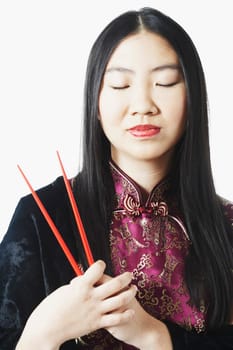 Close-up of a young woman holding chopsticks