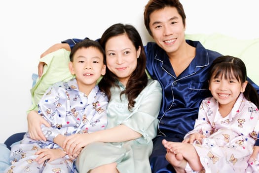 Close-up of a mid adult man and a young woman smiling with their children