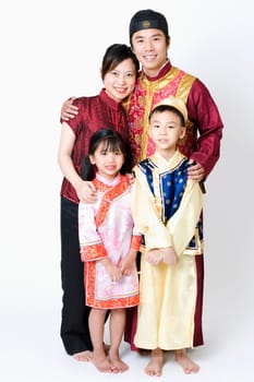 Portrait of a mid adult man and a young woman standing with their children