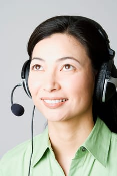 Close-up of a businesswoman smiling with a headset