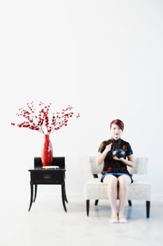 Portrait of a young woman holding a tea kettle