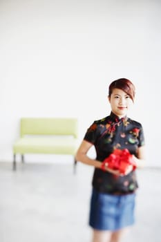 Portrait of a young woman holding a gift in her hands