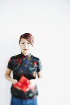 Portrait of a young woman holding a gift in her hands