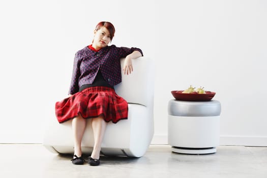 Portrait of a young woman sitting on a couch