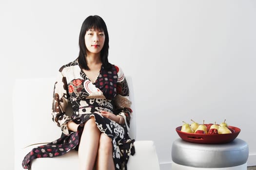 Portrait of a young woman sitting on a couch
